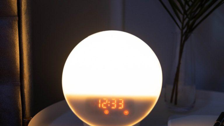 Glowing bedside clock at night, evoking Ward Pettibone's around-the-clock sleep electrophysiology work